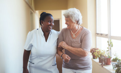 caregiver and senior woman laughing
